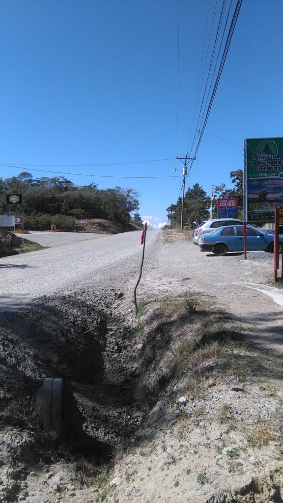 Beware of hole. These warning sticks are often shoved into holes in the middle of the road.